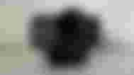 A black Elgato webcam with a large lens.